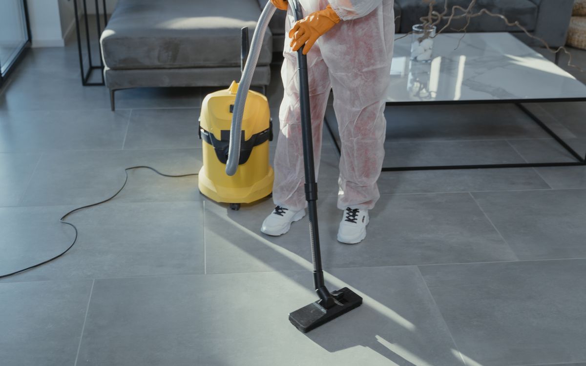 Technician extracting standing water with a wet vacuum
